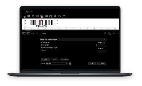 Laptop screen displaying barcode label design software with a printed barcode sample and a dark settings dialog nearby