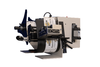 Industrial label printer with a roll of labels and a dark blue handle, mounted on a beige metal frame.